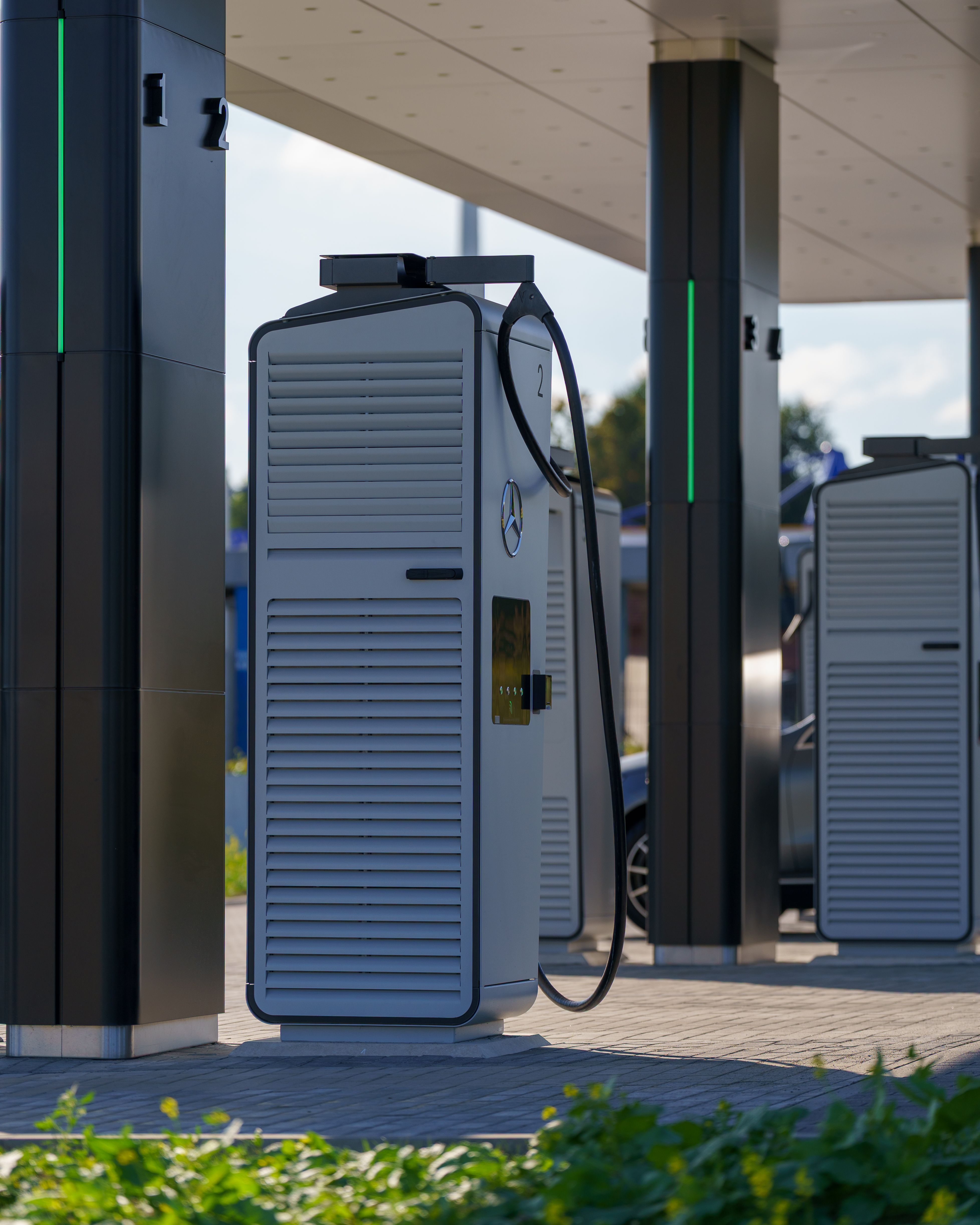 An outdoor public EV charging station with multiple charging posts