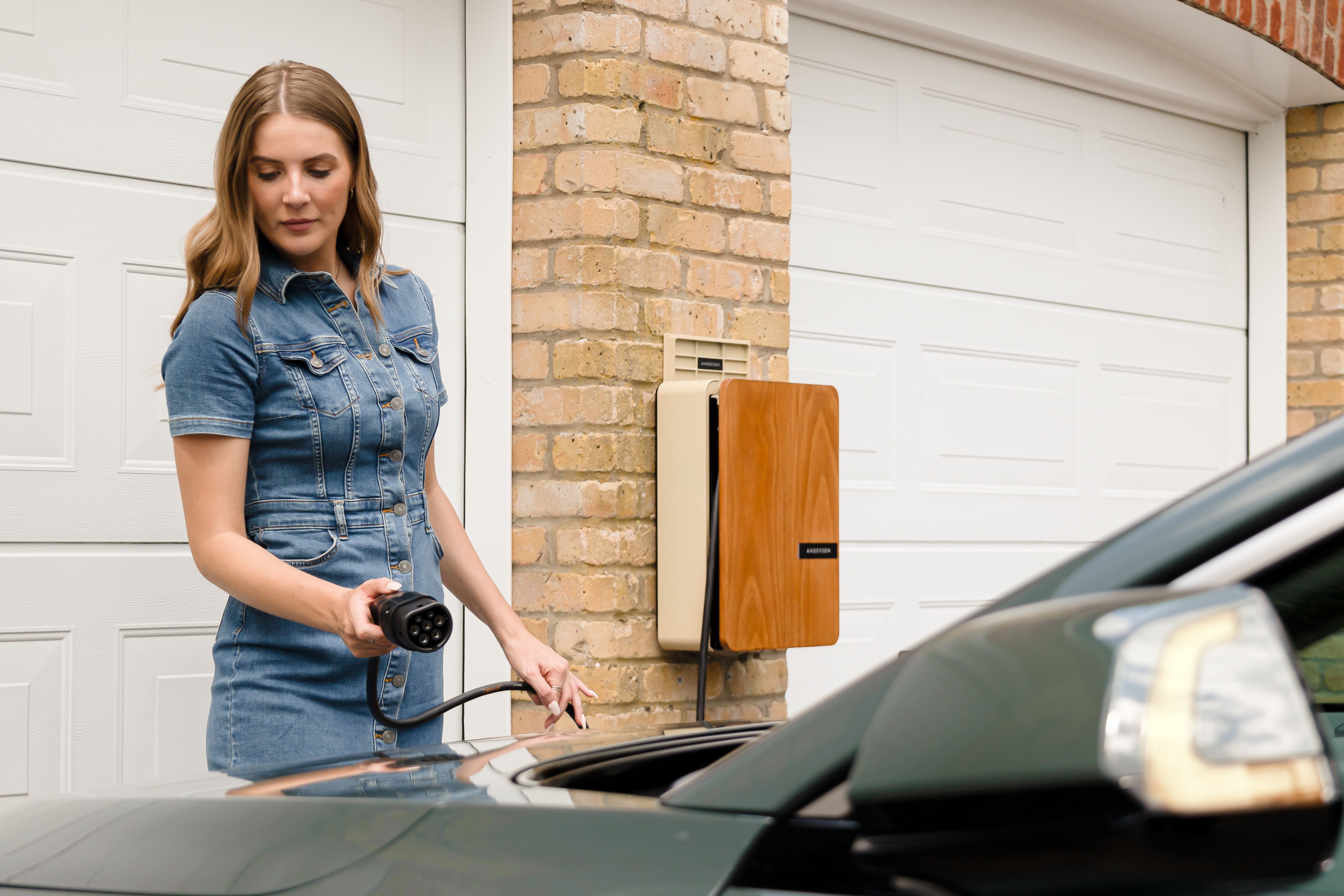 Plugging a charging cable into an EV at a home charge point